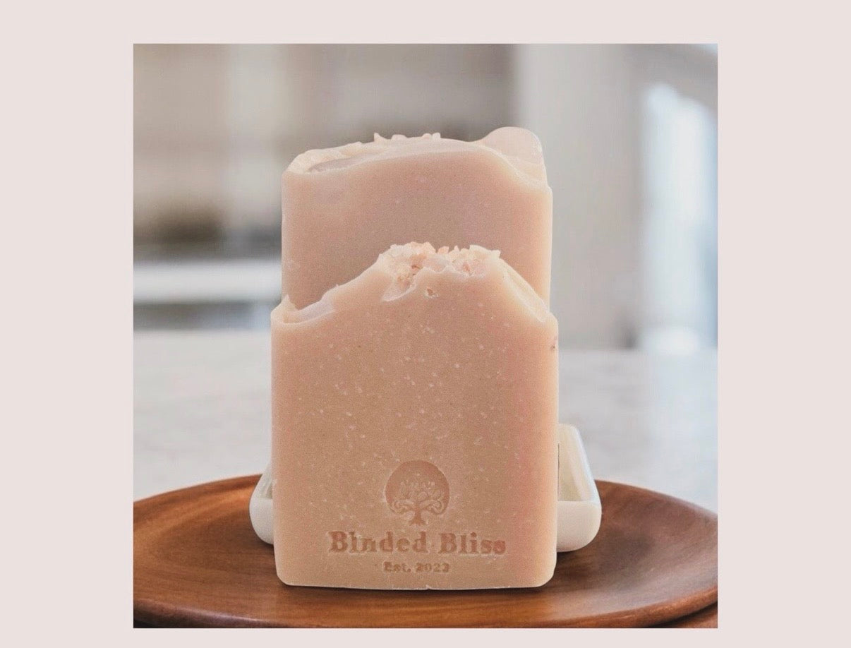 Two bars of Blnded Bliss Blush bars, on a wooden plate.