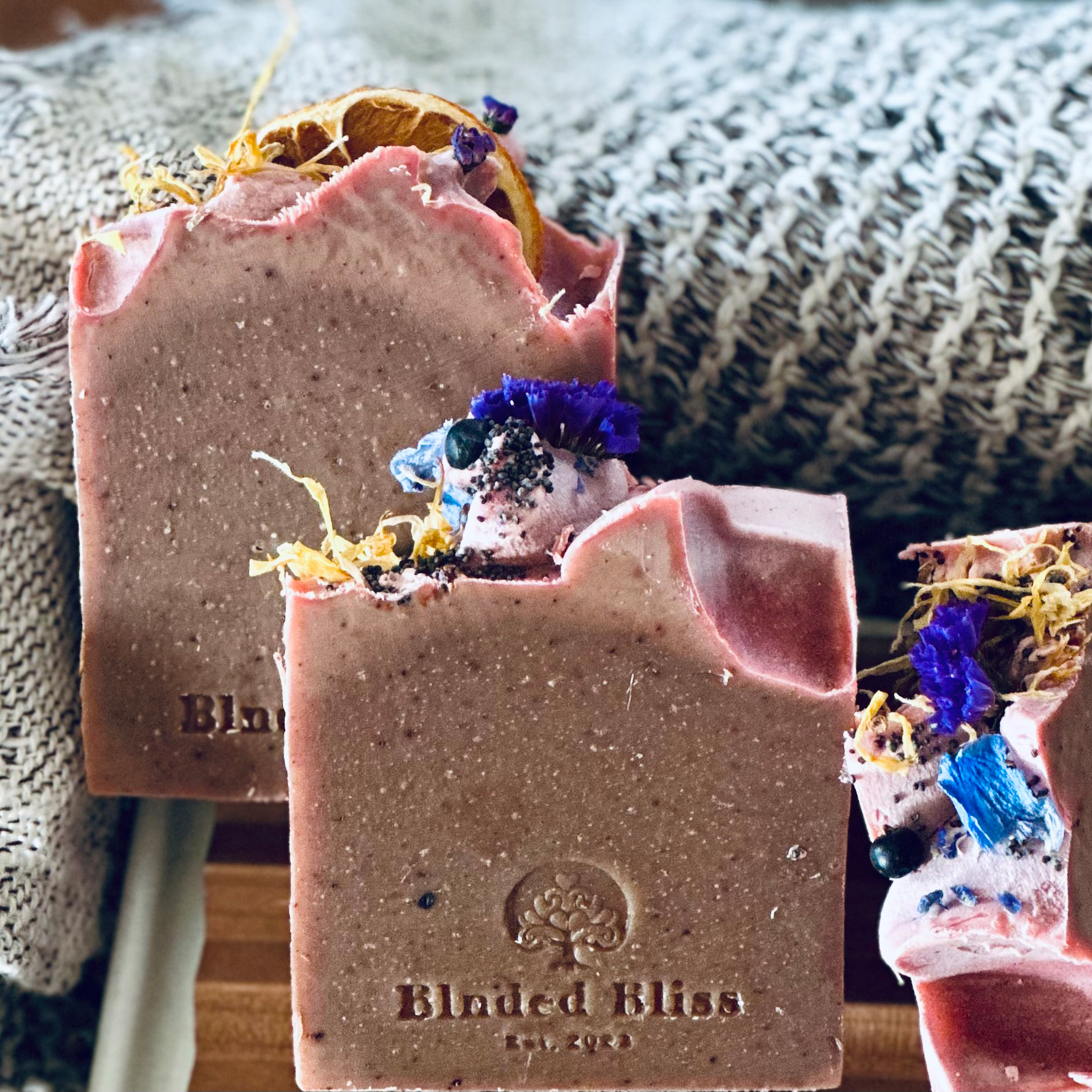 Golden Bloom Bar handmade soap by Blnded Bliss with embossed logo, natural coconut milk base, and subtle pink tones.