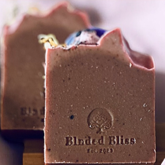 Handmade Golden Bloom Bar soap by Blnded Bliss with dried orange slice, calendula petals, and purple cornflower accents on top of a natural coconut milk soap bar.