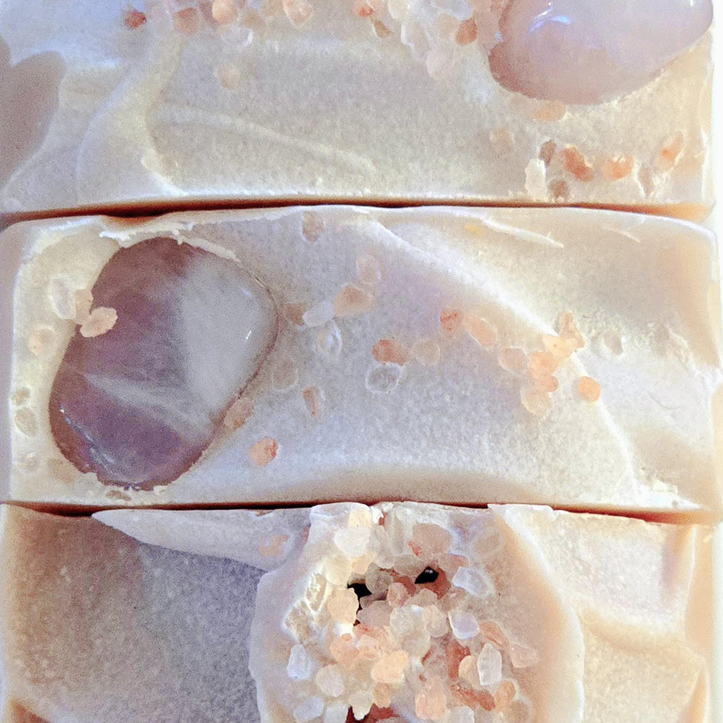 A top-down view of the Blush soap bars, showing the decorative Himalayan pink salt crystals and embedded rose quartz stones that adorn the soap’s surface.