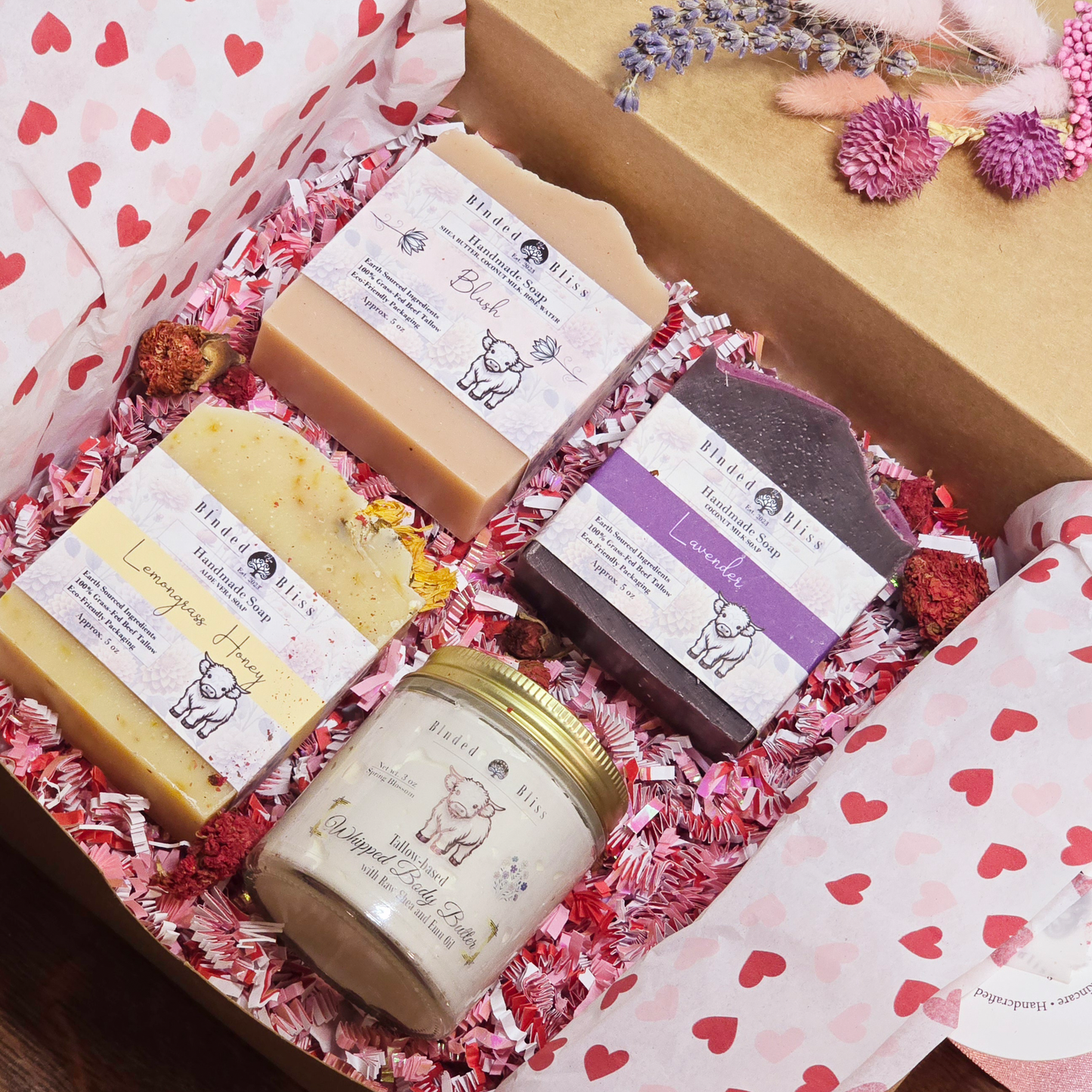 Luxurious handmade soap and body butter gift set with natural ingredients in festive packaging.